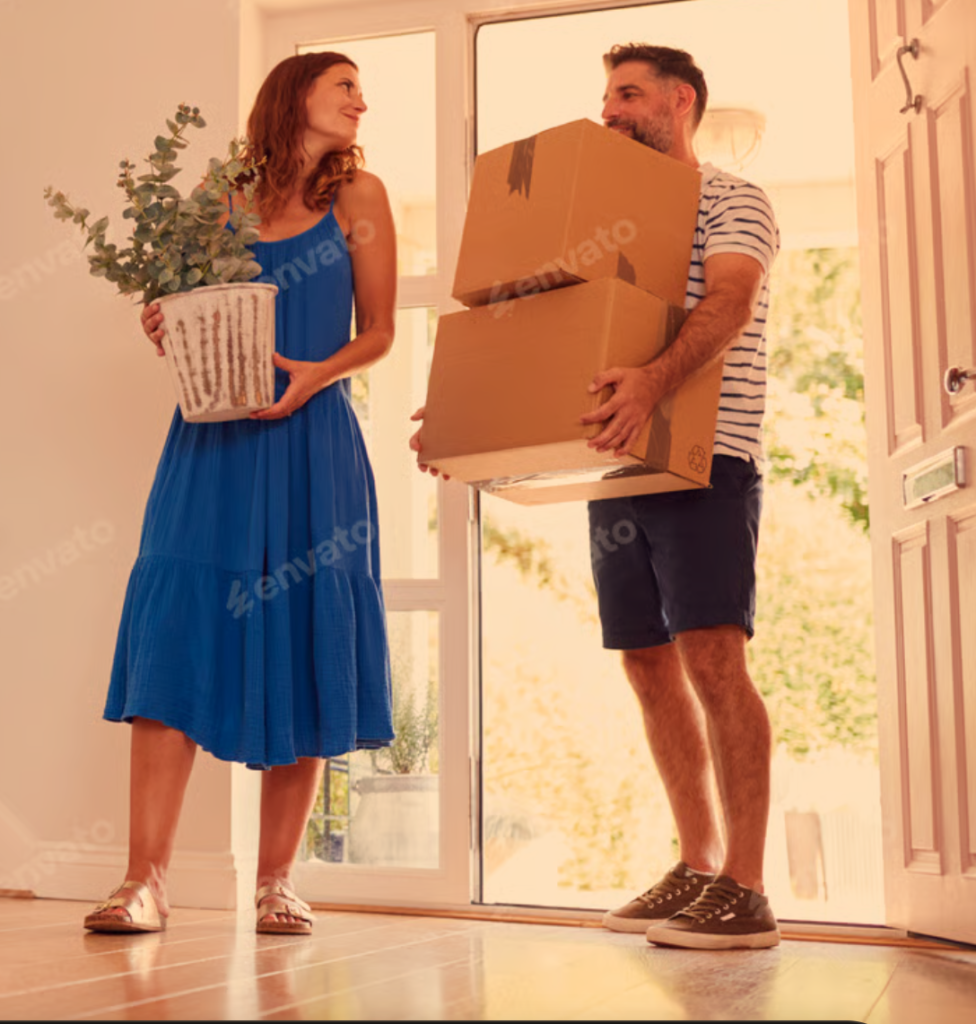 Happy new homeowners moving boxes and plants into their new Plymouth, Massachusetts home

